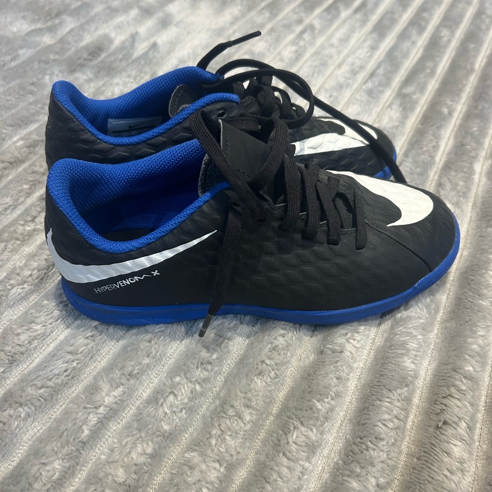 Nike Kids Black and Blue indoor soccer cleats.